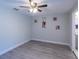 Bedroom with ceiling fan, wood-look flooring, and decorative wall art at 4515 Isaac Ln, Sanford, FL 32771