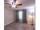 Bedroom features hardwood floors, neutral paint, a fan, and natural light from window at 4515 Isaac Ln, Sanford, FL 32771