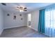 Bedroom features wood-look floors, ensuite bath, and window at 4515 Isaac Ln, Sanford, FL 32771