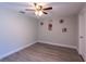 Neat bedroom featuring wood-look flooring, gray walls, and a ceiling fan at 4515 Isaac Ln, Sanford, FL 32771
