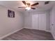 Cozy bedroom featuring light gray walls, wood-look flooring, and ceiling fan at 4515 Isaac Ln, Sanford, FL 32771