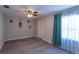 Light-filled bedroom with wood-look flooring, gray walls, and a window with curtains at 4515 Isaac Ln, Sanford, FL 32771