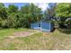 Exterior view of house showcasing the blue vinyl siding and green backyard at 4515 Isaac Ln, Sanford, FL 32771