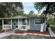 Charming single story home featuring a covered porch, complemented by a freshly landscaped yard and walkway at 4515 Isaac Ln, Sanford, FL 32771