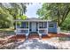 Charming blue home with a covered porch and inviting curb appeal at 4515 Isaac Ln, Sanford, FL 32771