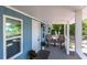 Inviting front porch with chairs, plants, and a storm door at 4515 Isaac Ln, Sanford, FL 32771