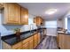 Spacious kitchen featuring granite counters, stainless appliances, and wood cabinetry at 4515 Isaac Ln, Sanford, FL 32771