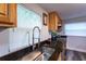 Bright kitchen with dark counters, stainless steel sink and appliances, and wood cabinets at 4515 Isaac Ln, Sanford, FL 32771