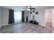Bright living room with modern flooring, complemented by decorative curtains and a ceiling fan at 4515 Isaac Ln, Sanford, FL 32771