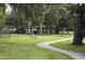Lush green park with benches, picnic areas, mature trees, and a winding walkway for enjoying the outdoors at 4515 Isaac Ln, Sanford, FL 32771