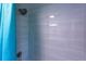 Modern shower featuring gray tile and updated shower head at 4515 Isaac Ln, Sanford, FL 32771
