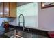 Bright kitchen sink area with granite countertops, modern faucet, and natural wood cabinets at 4515 Isaac Ln, Sanford, FL 32771