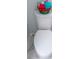 Close-up of white toilet with a basket of towels on top at 4515 Isaac Ln, Sanford, FL 32771