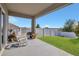 Inviting covered patio with rocking chairs, overlooking a neatly kept lawn and white fence, perfect for relaxation at 567 Pinecrest Loop, Davenport, FL 33837