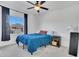 Inviting bedroom featuring a plush blue comforter, a window view and a small bedside table with storage at 567 Pinecrest Loop, Davenport, FL 33837