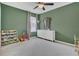 Bedroom with green walls, natural light, and white dresser; plenty of space for to play at 567 Pinecrest Loop, Davenport, FL 33837