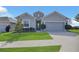 Charming single-story home features a well-manicured lawn and a two-car garage at 567 Pinecrest Loop, Davenport, FL 33837
