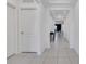 Bright hallway featuring tray ceiling, neutral walls, and tile flooring at 567 Pinecrest Loop, Davenport, FL 33837