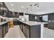 Modern kitchen with stainless appliances, granite counters, and pendant lights at 567 Pinecrest Loop, Davenport, FL 33837