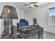 Home office with blue gaming chair and a window for natural light, perfect for working from home at 567 Pinecrest Loop, Davenport, FL 33837