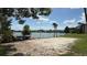 Sand volleyball court overlooking a serene lake with kayaks nearby at 592 Orange Dr # 142, Altamonte Springs, FL 32701