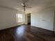 Bright bedroom with hardwood floors, a ceiling fan, and a view of the outdoors at 592 Orange Dr # 142, Altamonte Springs, FL 32701