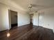 Bedroom with hardwood floors, a ceiling fan, and a closet providing ample storage at 592 Orange Dr # 142, Altamonte Springs, FL 32701