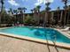 Sparkling community pool with lounge chairs surrounded by manicured landscaping at 592 Orange Dr # 142, Altamonte Springs, FL 32701