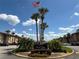 Welcome to Sandy Cove Condominiums sign with palms and blue sky at 592 Orange Dr # 142, Altamonte Springs, FL 32701