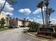 Welcoming community entrance featuring lush landscaping, palm trees, and access to Sandy Cove Condominiums at 592 Orange Dr # 142, Altamonte Springs, FL 32701