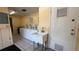 Bright laundry room featuring multiple washers, a utility sink, and tiled floors at 592 Orange Dr # 142, Altamonte Springs, FL 32701