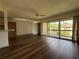 Bright living room with hardwood floors, ceiling fans, and sliding glass doors to a balcony at 592 Orange Dr # 142, Altamonte Springs, FL 32701