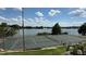 Tennis court with a beautiful lake view under a partly cloudy sky at 592 Orange Dr # 142, Altamonte Springs, FL 32701