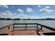 Wooden deck overlooking a serene lake with clouds reflected in the water at 592 Orange Dr # 142, Altamonte Springs, FL 32701
