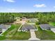 This aerial view showcases the property and its surroundings, including neighboring houses and green spaces at 606 Marion Oaks Blvd, Ocala, FL 34473