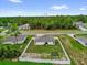 An aerial view of the property showcasing a fenced backyard, lush greenery, and surrounding neighborhood at 606 Marion Oaks Blvd, Ocala, FL 34473