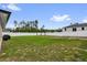 Expansive backyard features a privacy fence, lush green lawn, and a pergola ready for outdoor living and entertaining at 606 Marion Oaks Blvd, Ocala, FL 34473