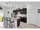 Modern kitchen with stainless steel appliances, granite countertops, dark cabinetry, and a breakfast bar at 606 Marion Oaks Blvd, Ocala, FL 34473