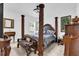 Spacious main bedroom with an ornate four-poster bed and a side table at 606 Marion Oaks Blvd, Ocala, FL 34473