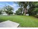 A spacious backyard with a large tree provides ample shade for outdoor activities at 606 Ohio Ave, St Cloud, FL 34769