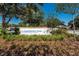 The Lakefront Park entrance sign is surrounded by lush greenery and mature trees at 606 Ohio Ave, St Cloud, FL 34769