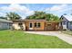 Lovely single-story home with a covered front porch and lush green lawn at 606 Ohio Ave, St Cloud, FL 34769