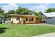 Inviting single-story home featuring a covered porch and a well-manicured front lawn at 606 Ohio Ave, St Cloud, FL 34769