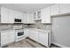 Bright kitchen features stainless steel appliances, ample cabinet space, gray tile backsplash, and luxury vinyl flooring at 606 Ohio Ave, St Cloud, FL 34769