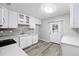 Bright kitchen with modern countertops, stainless steel sink, white cabinetry, and luxury vinyl plank flooring at 606 Ohio Ave, St Cloud, FL 34769