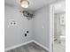 The laundry room features gray tile flooring, a utility sink and hookups for a washing machine and dryer at 606 Ohio Ave, St Cloud, FL 34769
