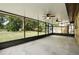 The home has a spacious screened in patio with ceiling fans and views of the large back yard at 606 Ohio Ave, St Cloud, FL 34769