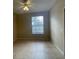 Simple bedroom with tile flooring, a window, and a closet at 6169 Metrowest Blvd # 102, Orlando, FL 32835