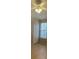 A simple bedroom with tiled floors, a window, and a closet at 6169 Metrowest Blvd # 102, Orlando, FL 32835