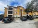 Beautiful apartment building with a balcony and parking spaces on a sunny day at 6169 Metrowest Blvd # 102, Orlando, FL 32835